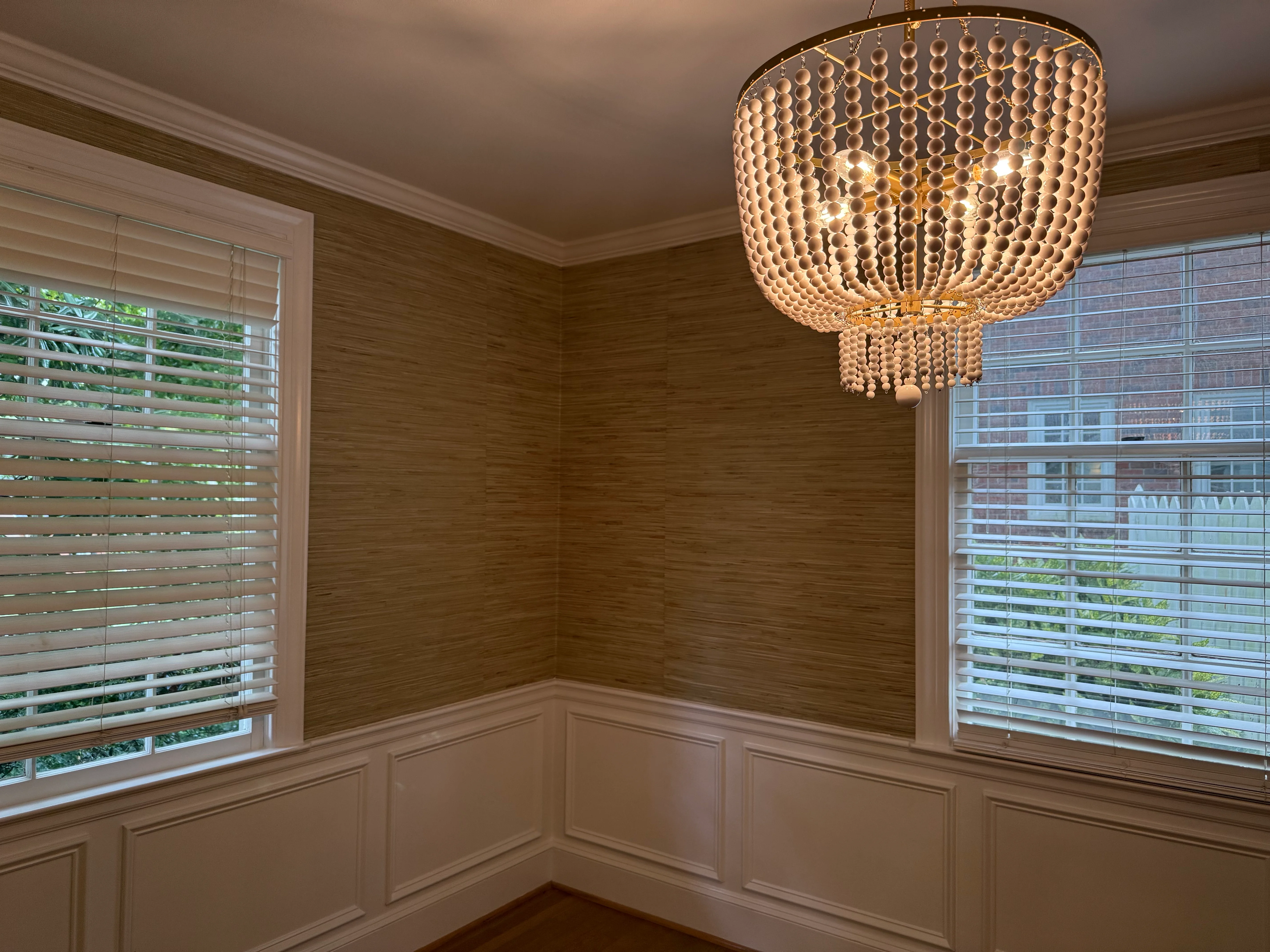 A kitchen ceiling papered in a delicate pale blue and grey geometric floral pattern, viewed looking up from the room below.